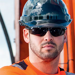 Image of a man wearing sun safety glasses and hard hat.